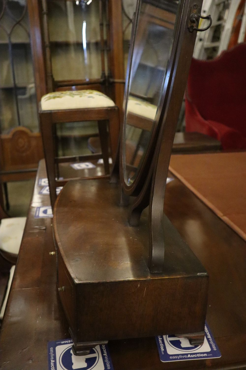 A George III mahogany toilet mirror with bow front box base, width 55cm, depth 22cm, height 72cm